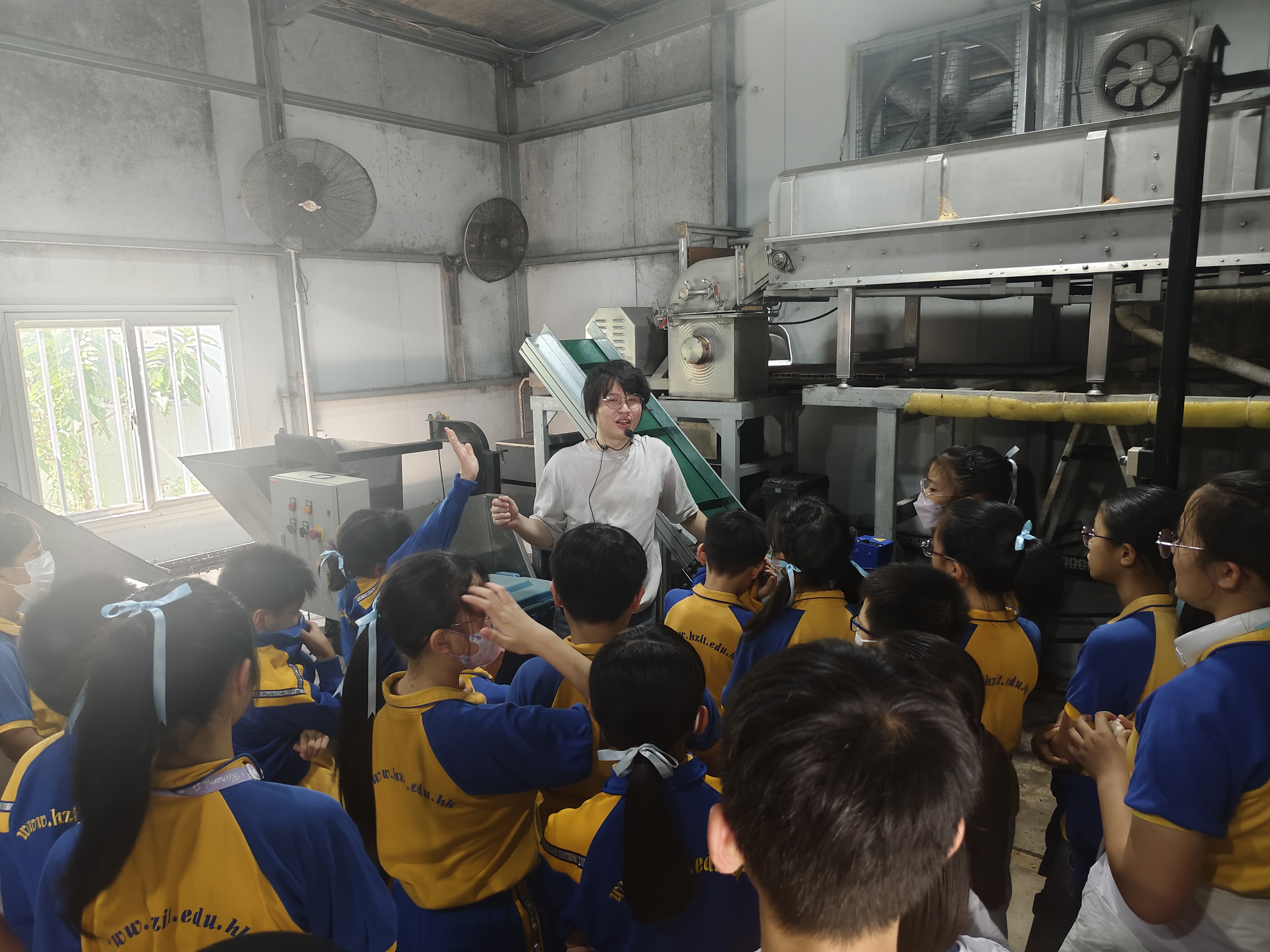 Tour Guide introducing food waste processing machinery